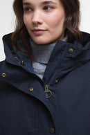 Navy waterproof jacket close-up with zip placket and gold snap buttons