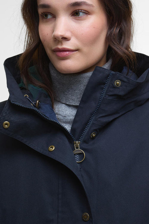 Navy waterproof jacket close-up with zip placket and gold snap buttons