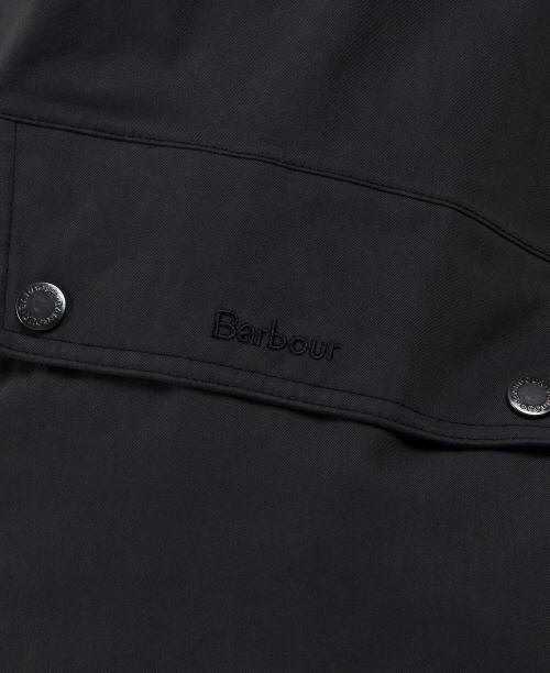 Navy waterproof jacket with Barbour logo and snap buttons on placket