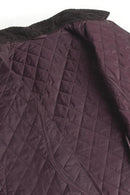 Quilted jacket panel in dark plum with diamond stitching and zippered seam detail