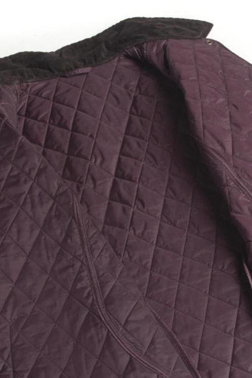 Quilted jacket panel in dark plum with diamond stitching and zippered seam detail