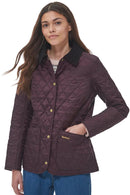 Front view of dark plum quilted jacket with gold buttons, stand collar, and front pocket