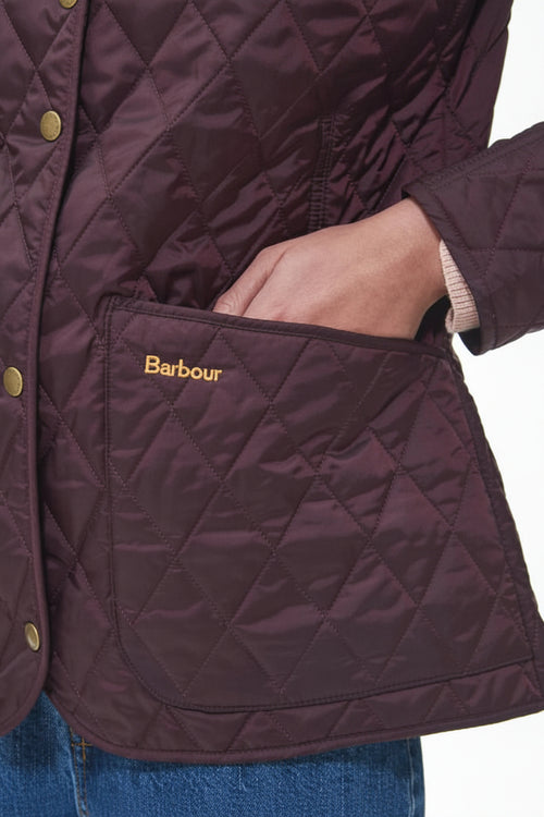 Dark plum quilted jacket with gold button placket and front pocket, Barbour patch