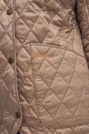 Sand quilted Barbour jacket with diamond stitching, snap buttons, stand collar.