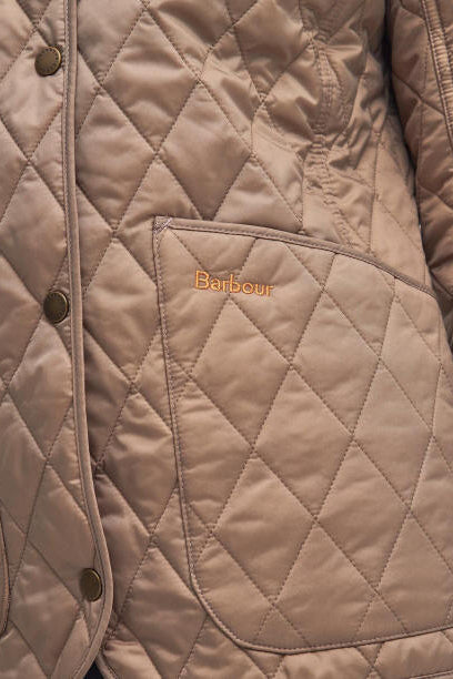 Sand quilted Barbour jacket with diamond stitching, snap buttons, stand collar.