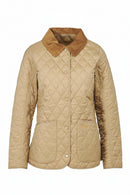 Tan quilted jacket on mannequin with diamond stitching, brown collar, button front.
