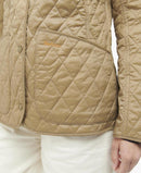 Quilted tan jacket with diamond pattern, snap button placket, Barbour logo patch.