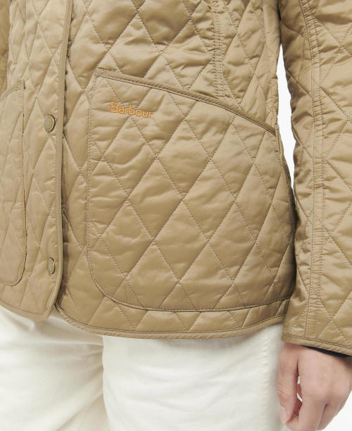 Quilted tan jacket with diamond pattern, snap button placket, Barbour logo patch.