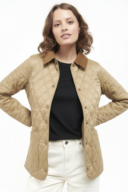 Women’s quilted jacket in tan with diamond stitching, brown collar, button front.