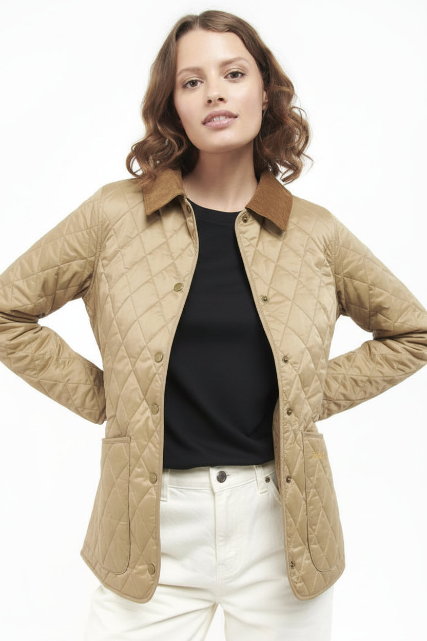 Women’s quilted jacket in tan with diamond stitching, brown collar, button front.