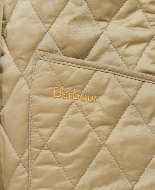 Barbour logo on quilted tan diamond-stitched jacket front panel with topstitching.