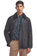 Barbour wax jacket in dark brown with button front and flap pockets, standing collar.