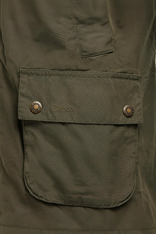 Olive Barbour jacket chest pocket with Barbour logo patch and snap closure