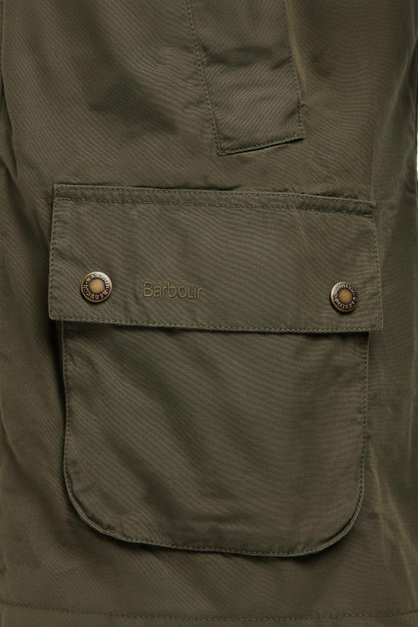 Olive Barbour jacket chest pocket with Barbour logo patch and snap closure