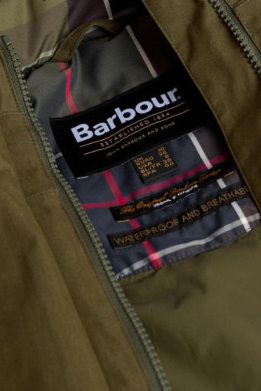 Olive waterproof jacket inner label with Barbour branding and plaid lining detail