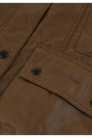 Brown jacket pocket flap with Barbour logo and metal button detail