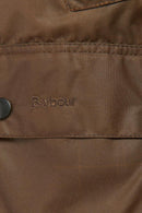 Barbour label on bark brown waxed jacket interior panel with visible stitching