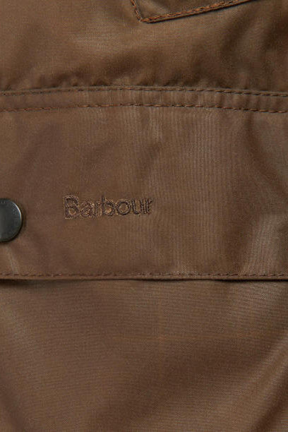 Barbour label on bark brown waxed jacket interior panel with visible stitching