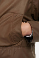 Bark brown waxed jacket sleeve and pocket panel with buttoned cuff detail