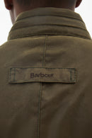 Barbour label on olive wax jacket collar with dark snap buttons