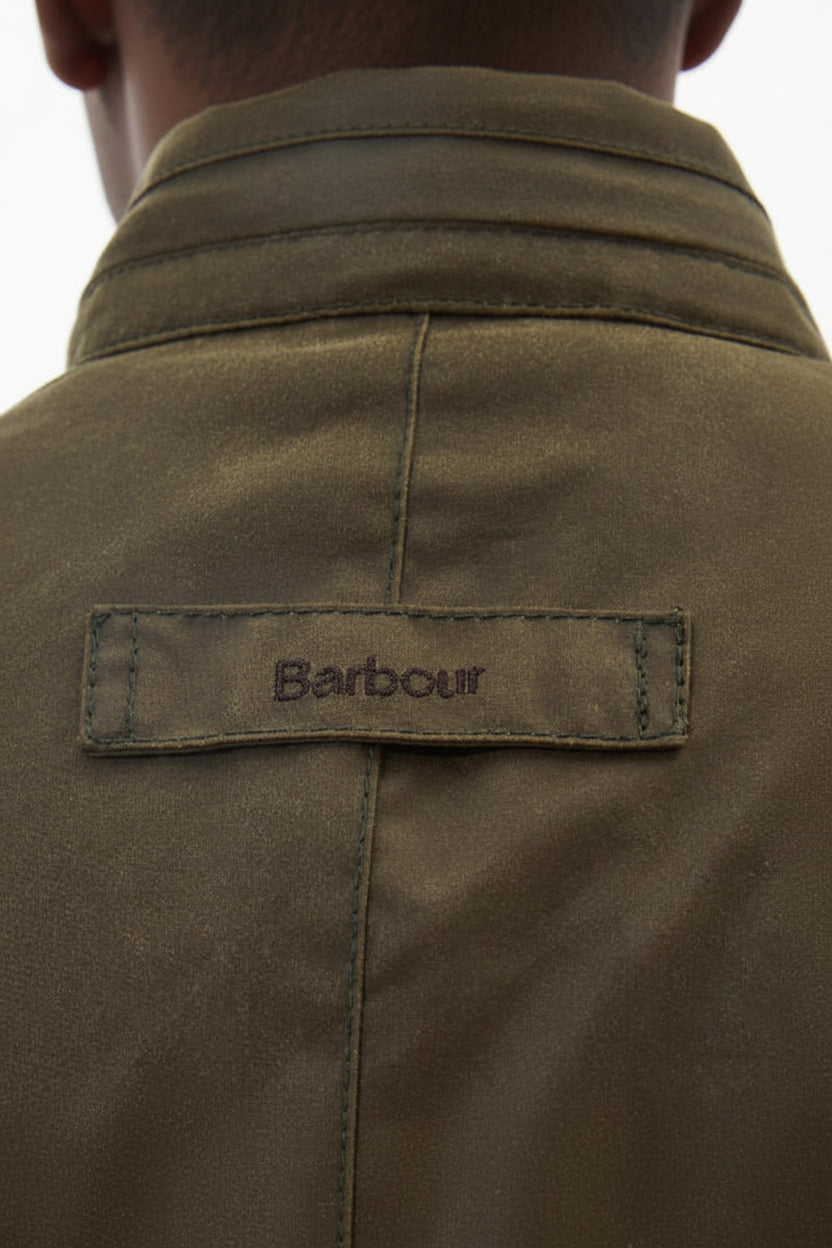 Barbour label on olive wax jacket collar with dark snap buttons