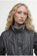Women’s black wax jacket with stand collar, front button placket, and close-up detail