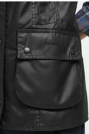 Black jacket pocket flap with Barbour logo and snap button detail