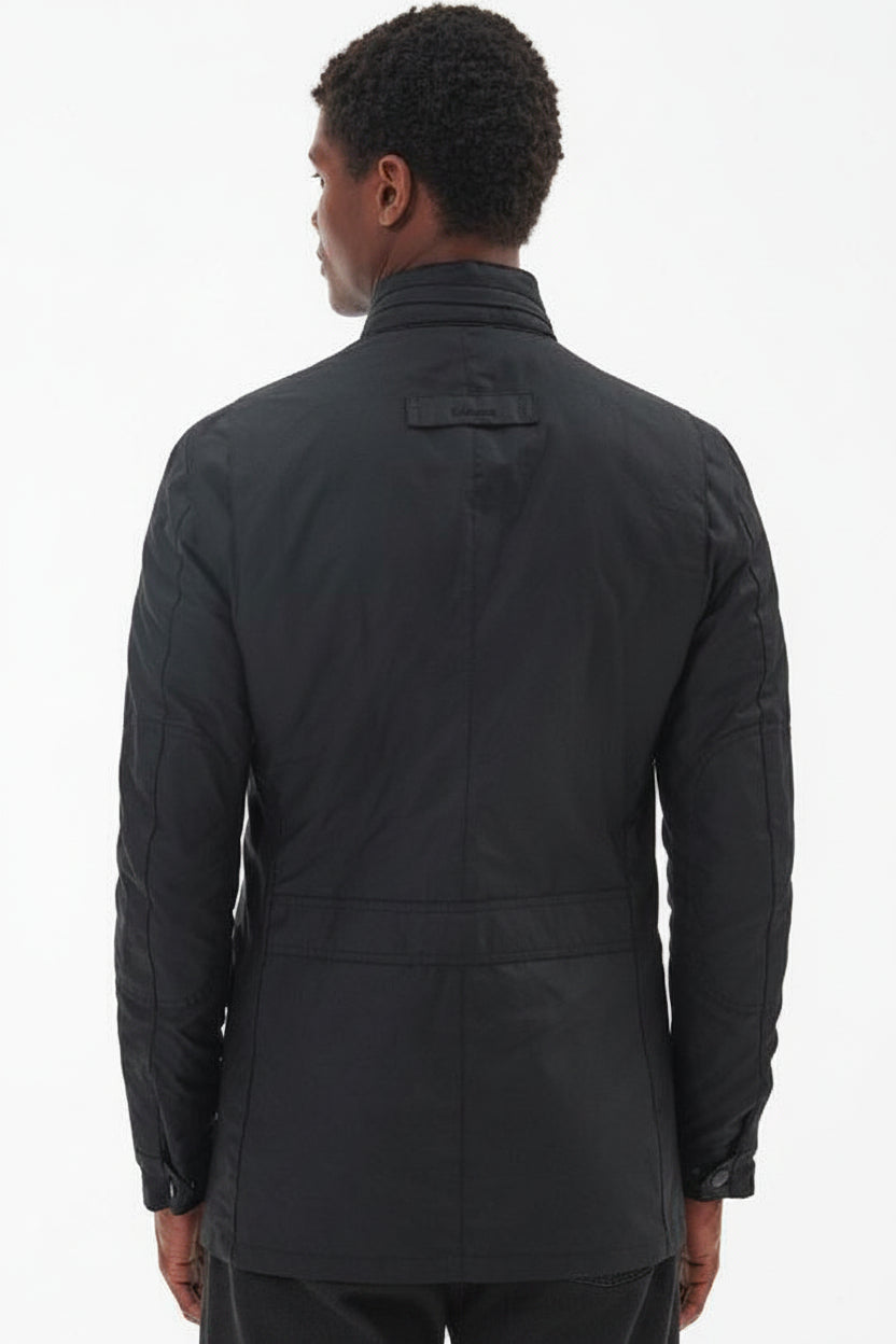 Men's black wax jacket, back view, with stand collar and horizontal seam bands.