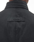 Men's black wax jacket back yoke with Barbour logo label.