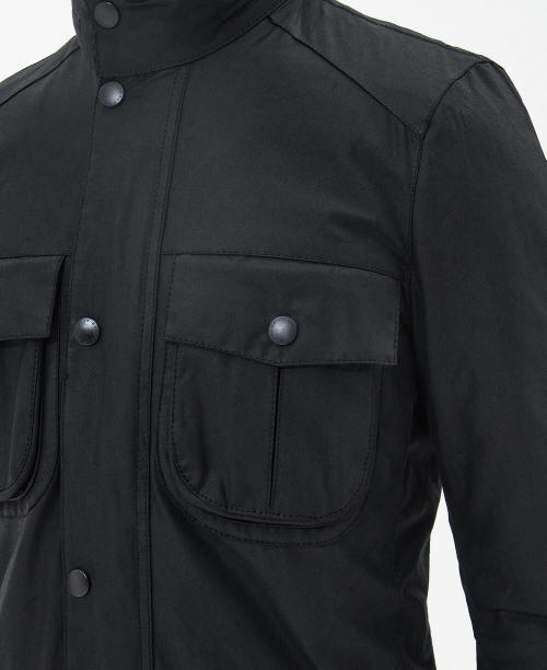 Men's black wax jacket front panel with flap pocket and snap buttons.