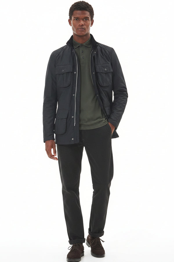 Men's black wax jacket with stand collar and chest flap pockets, worn open over shirt.