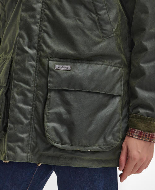 Dark green waxed jacket with Barbour patch on front pocket and visible fabric texture.