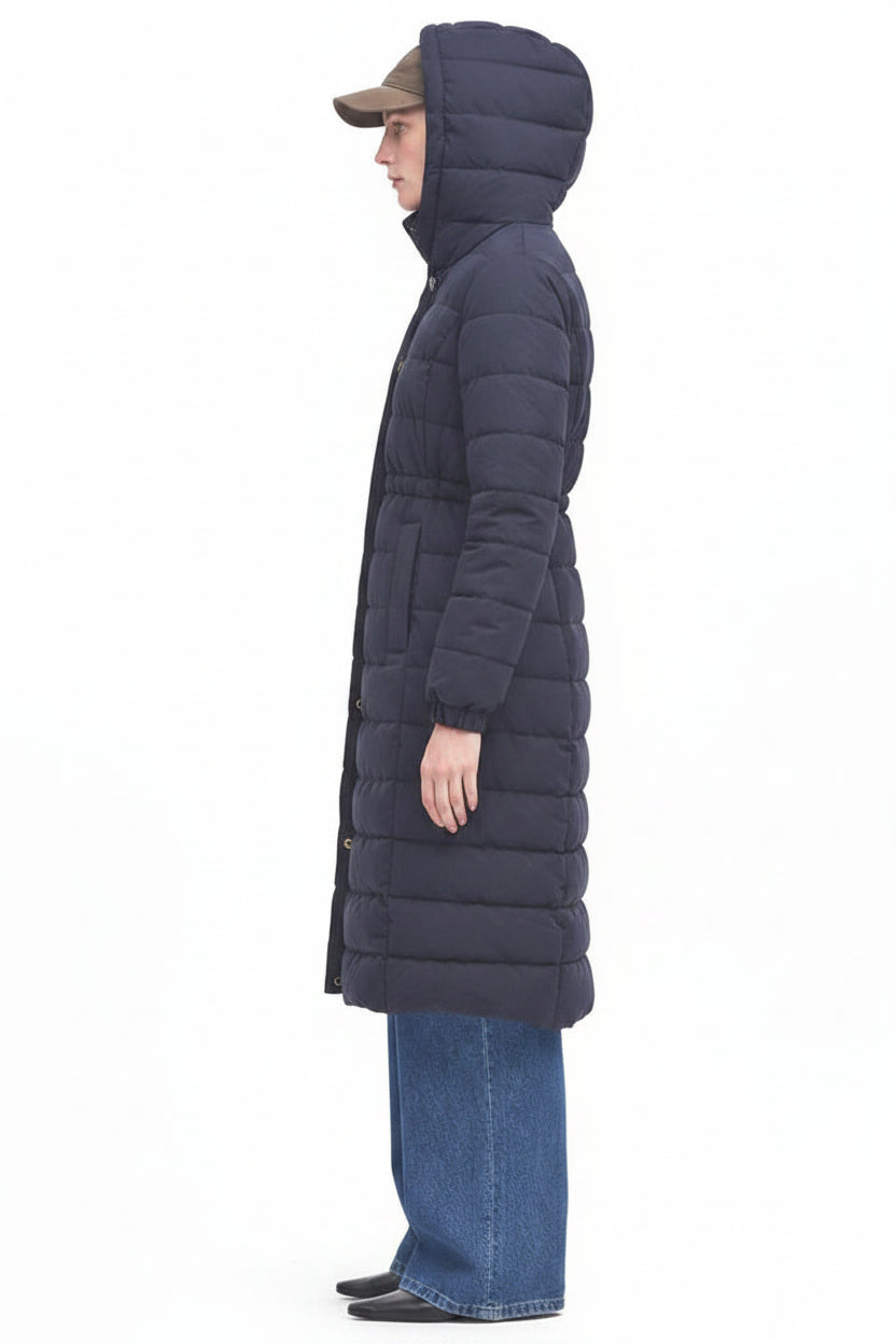 Navy side view of long hooded puffer jacket with quilted sections