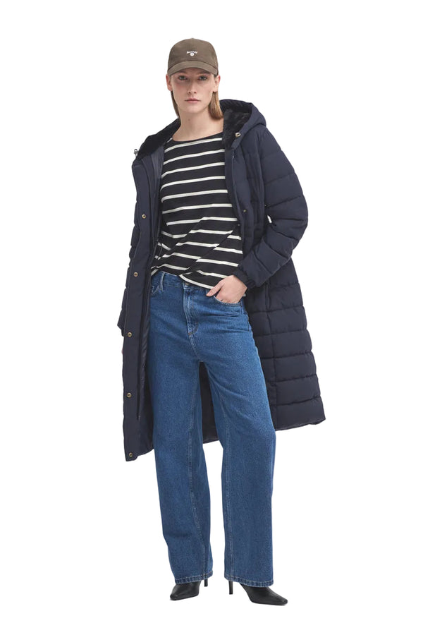 Navy hooded puffer parka worn over striped top and jeans
