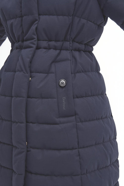 Navy quilted puffer jacket close-up with belted waist and round snap button