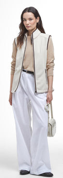 Cream fleece sleeveless gilet vest with full zip, dark trim, and drawstring pocket