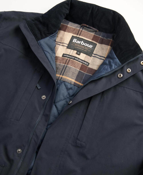 Navy waterproof jacket interior lining with Barbour label near the zip collar.
