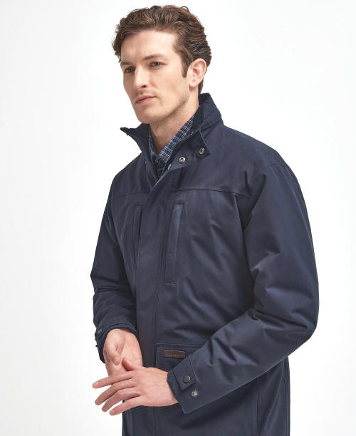 Men's navy waterproof jacket side profile with adjustable cuffs and pocket flaps.