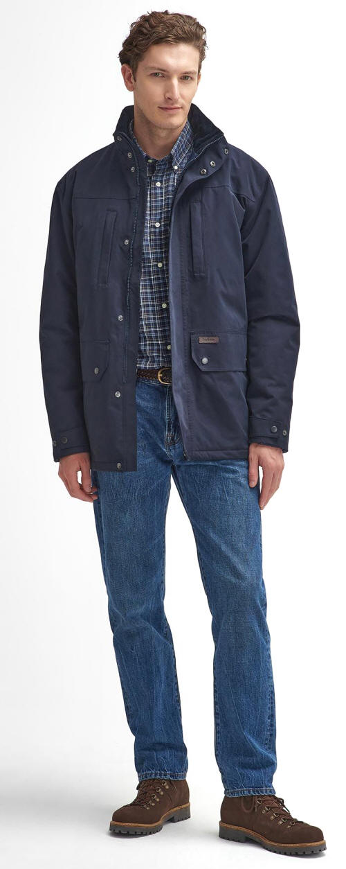 Men's navy waterproof jacket worn over a plaid shirt with blue jeans.