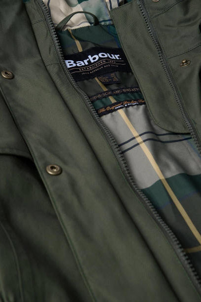 Barbour logo label on plaid lining inside olive waterproof jacket collar close-up