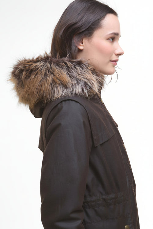 Dark waxed parka with wide fur-trimmed hood, side-back view, snap cuff