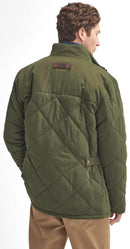 Olive quilted jacket back with diamond stitching and leather brand patch on yoke.