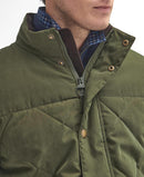 Olive quilted jacket with zip front, button details at collar, and diamond stitching.