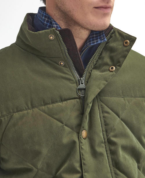 Olive quilted jacket with zip front, button details at collar, and diamond stitching.