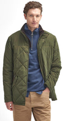 Olive quilted jacket with snap-button front and diamond quilting over blue layer.