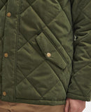 Olive quilted jacket close-up with button placket and diamond-stitched pocket panel.