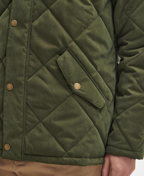 Olive quilted jacket close-up with button placket and diamond-stitched pocket panel.