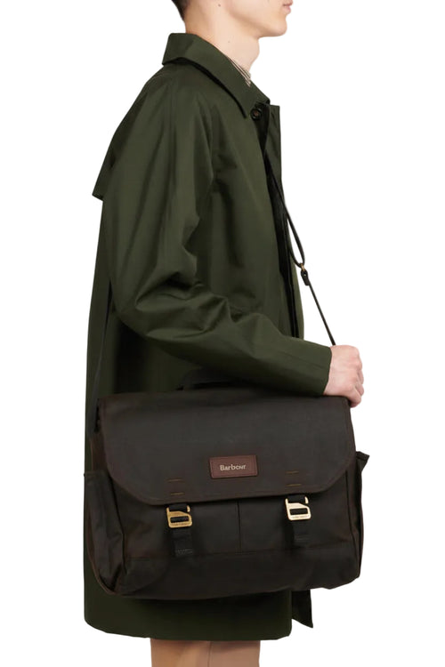 Olive wax messenger bag worn crossbody, flap with twin gold buckles