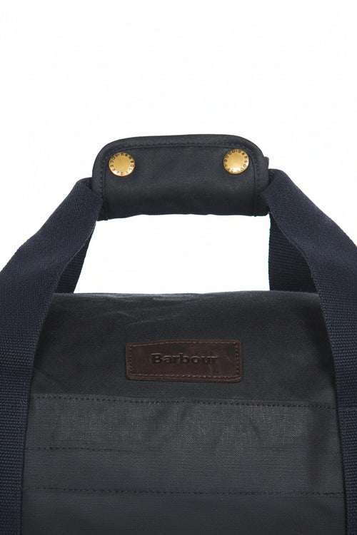 Dark navy duffle bag front with leather Barbour patch and top handle eyelets