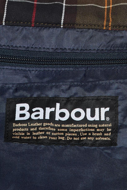 Barbour care label on dark navy wax duffle bag front patch